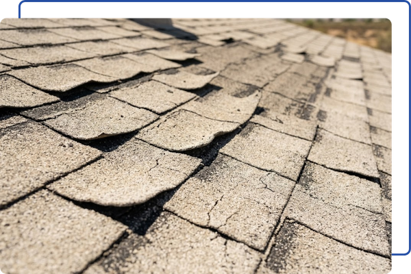a section of weathered, sun-bleached asphalt roofing shingles on an Arizona roof